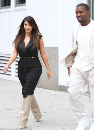 Trying to keep them under-Kover! Kim Kardashian grapples with her cleavage-baring dress as she shops with Kanye   5